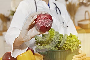Female nutritionist showing red apples to nourish the brain Health and nutrition from experts concept.