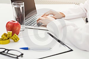 Female nutritionist working on laptop photo