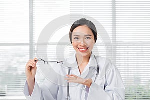 Female oculist giving a pair of eyeglasses