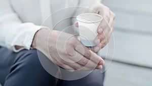 Female office employee sitting and drinking takeaway coffee