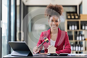 Female office worker, Auctioneer knocking down a property sale. Gavel wooden and house for home buying or selling of