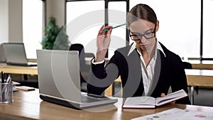 Female office worker correcting schedule, thinking over business meetings timing