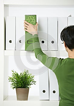 Female office worker with green folder