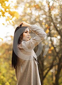 female office worker has fun in autumn park during lunch time,solitude with nature. Stress relief.Vertical plane