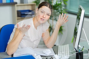 female office worker making questioning gesture incomprehension photo