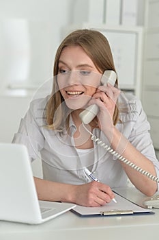 Female office worker reacting to phone call.