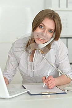 Female office worker reacting to phone call.