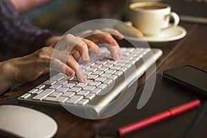 Female office worker typing on the computer keyboard. Work.