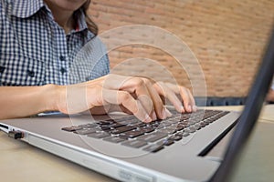 Female office worker typing on the keyboard close up.