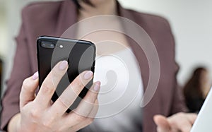 Female office worker typing on the phone, working at home office hand on keyboard