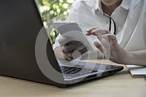 Female office worker using her mobilephone in modern office