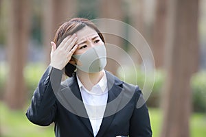 Female office worker wiping sweat