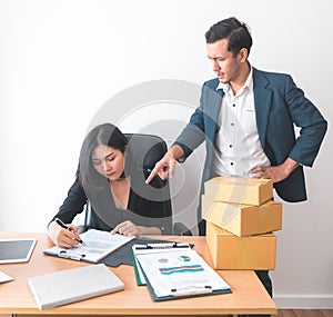 Female office worker working under pressure from supervisor photo