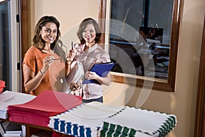 Female office workers standing in mailroom