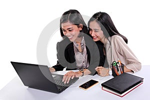 Female office workers using laptop together