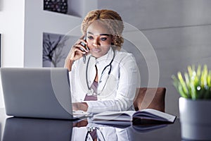 Female online doctor speaking on the phone