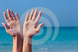 Female open hands on sea background