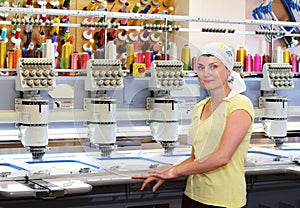 Female operator of automatic embroidery machines