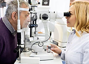 Female ophthalmic doctor check eyes man in eye clinic