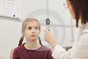 Female Ophthalmologist Examining Little Girl in Clinic