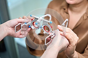 Female ophthalmologist uses a professional device in her work