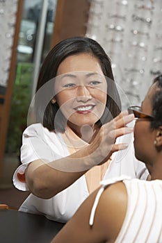 Female Optometrist Assisting Patient