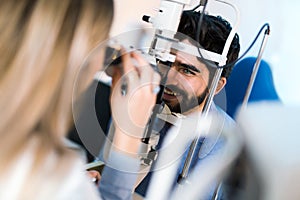 Optometrist checking patient eyesight and vision correction
