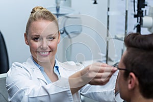 Female optometrist prescribing spectacles to patient