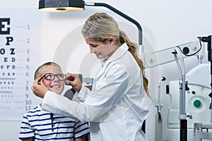 Female optometrist prescribing spectacles to young patient