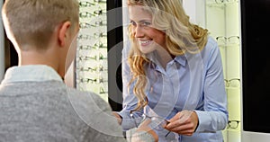 Female optometrist prescribing spectacles to young patient