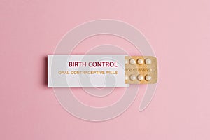 Female oral contraceptive pills blister on pink background. Women contraceptive hormonal birth control pills