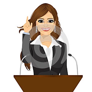 Female orator standing behind a podium with microphones