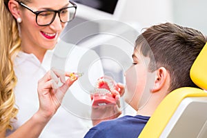 Female Orthodontist explaining boy photo