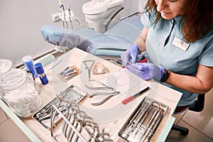 Female orthodontist working in dental office.