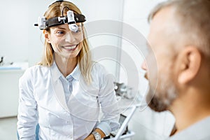 Female otolaryngologist with adult patient at the ENT office