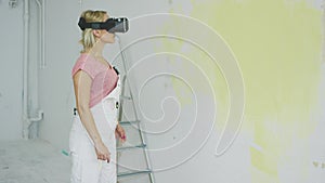 Female in overalls using virtual reality headset