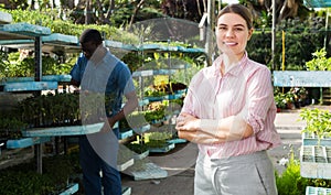 Female owner posing in greenhouse