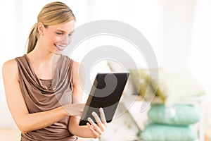 Female Owner Using Digital Tablet In Bedding Store