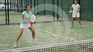 Female paddle tennis player during couple match at court