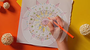 Female painting mandalas antistress page to combat stress. Relaxing hobby mental wellbeing and art therapy. Woman paints