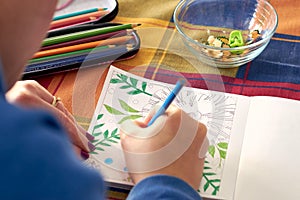 Female painting mandalas to combat stress caused by confinement to prevent coronavirus COVID-19