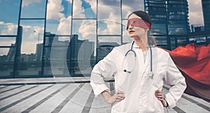 Female paramedic in a superhero raincoat standing on a city street.