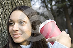 Female in a park drinking coffee