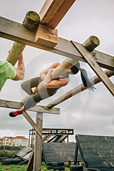 Participant in a obstacle course doing weaver photo