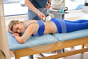 Female patient attending extracorporeal shock wave therapy