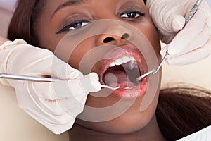 Female patient being checked by dentist