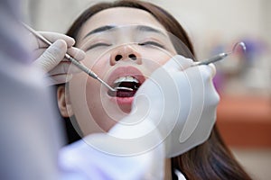 Female patient being examined by dentist