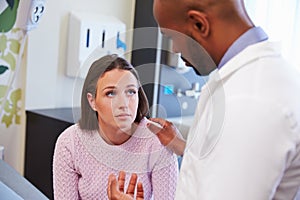 Female Patient Being Reassured By Doctor In Hospital Room photo