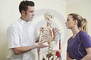 Female Patient In Consultation With Osteopath