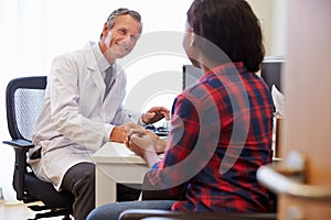 Female Patient Having Consultation With Doctor In Office